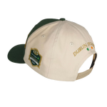 The College Football Ireland Store’s Click & Collect Joint Team Cap is beige and green with DUBLIN IRELAND, three stars embroidered on the back, a 2023 Aer Lingus College Football Classic patch on the side, and is shown on a white mannequin head.