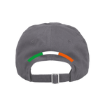 The Click & Collect K-State Grey Cap from College Football Ireland Store is a dark gray baseball cap shown from the back, with a curved stripe in green, white, and orange above the adjustable strap.